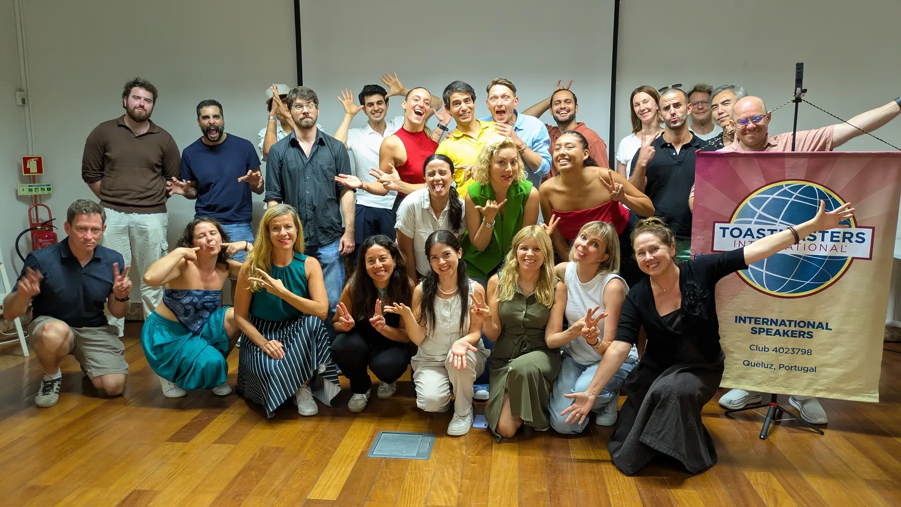 International Speakers members posing playfully together at a club meeting